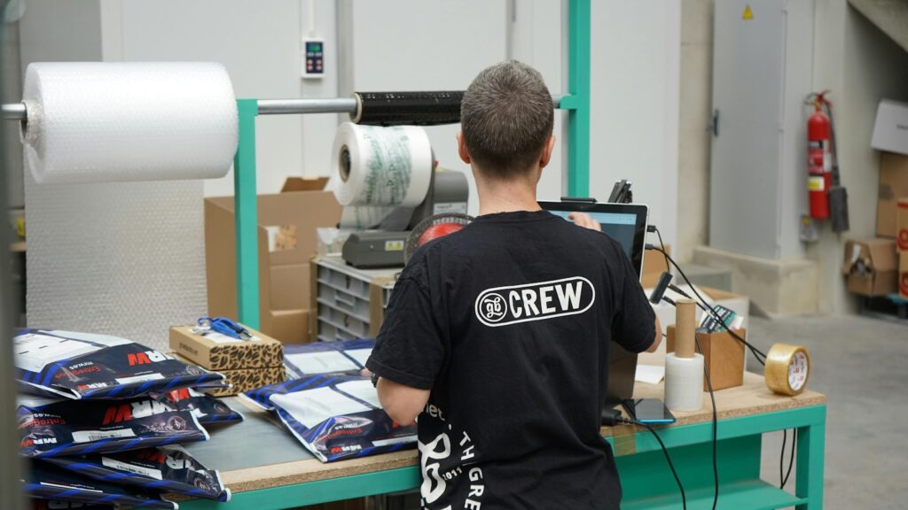 A man standing in front of a machine in a factory